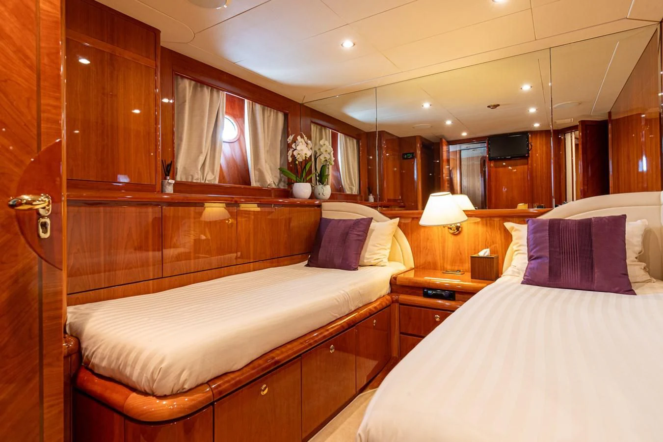 a room with a bed and a desk aboard BEIJA FLORE Yacht for Charter