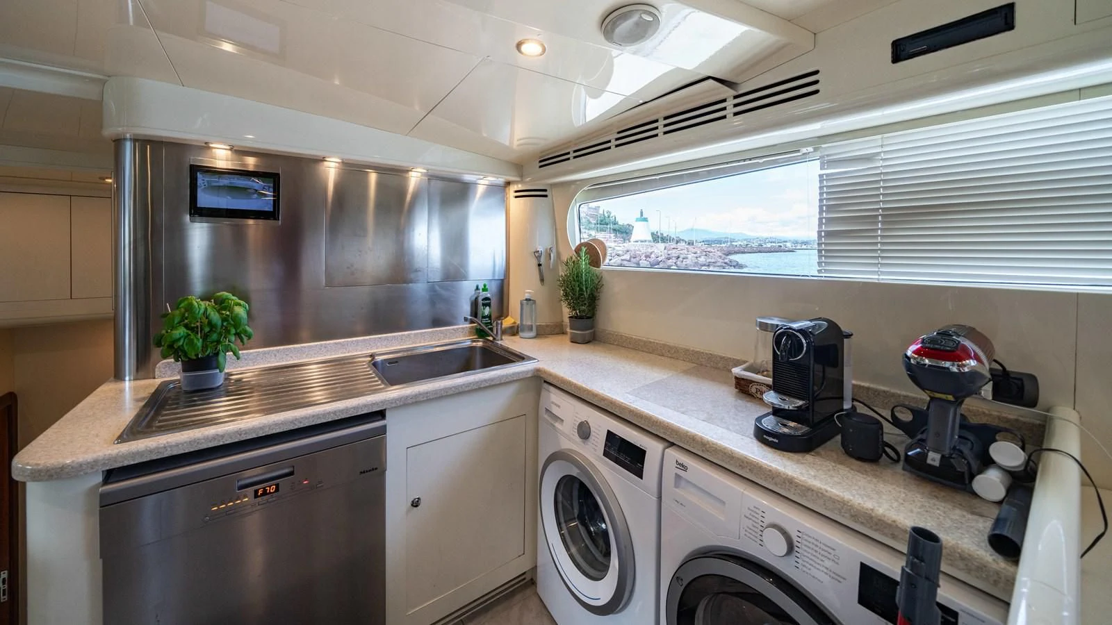 a kitchen with a large window aboard BEIJA FLORE Yacht for Charter