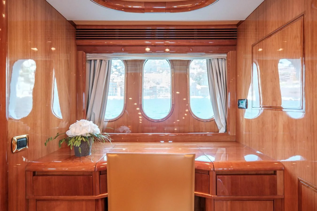 a room with a window and a chair aboard BEIJA FLORE Yacht for Charter