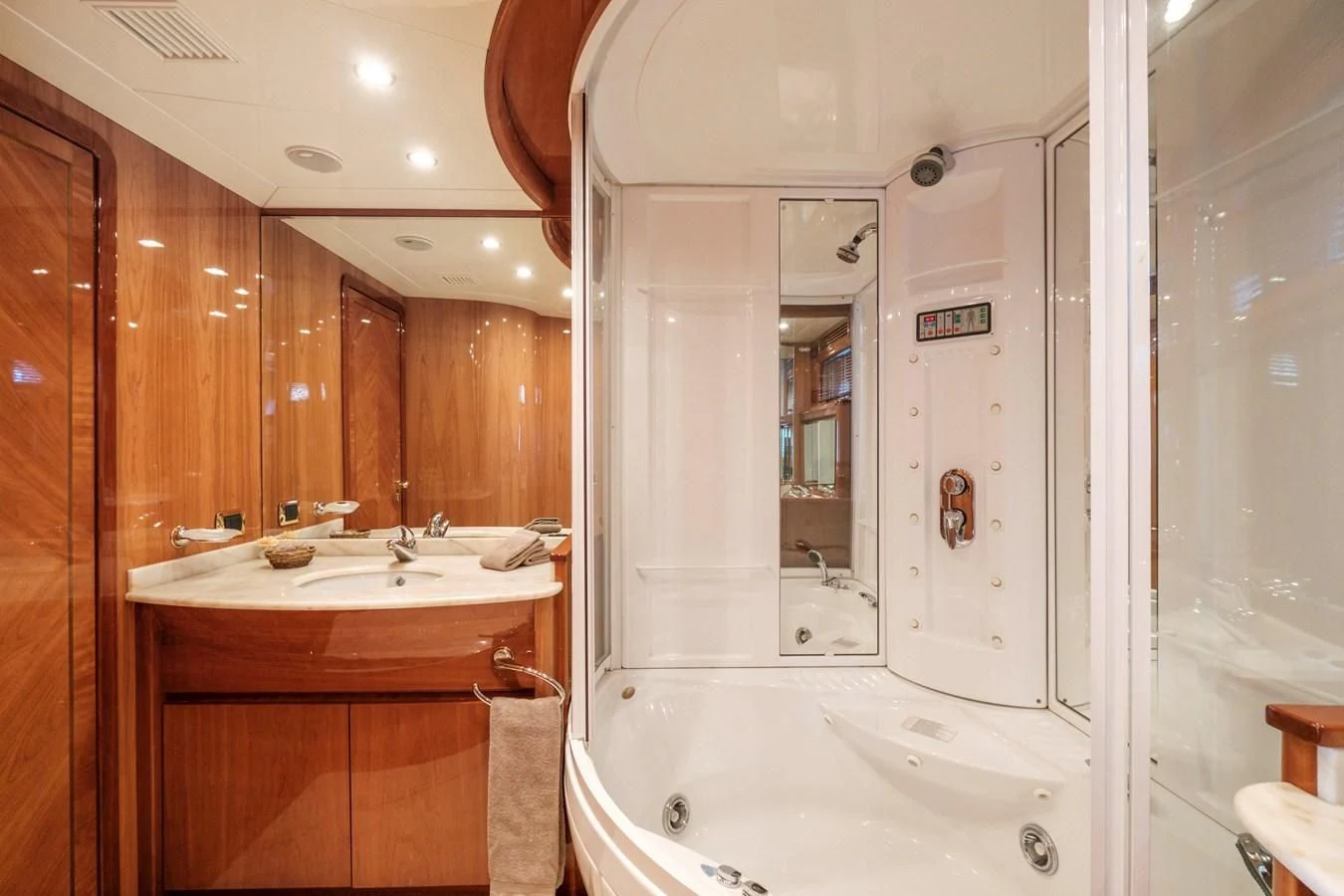 a bathroom with a bathtub sink and a sink aboard BEIJA FLORE Yacht for Charter