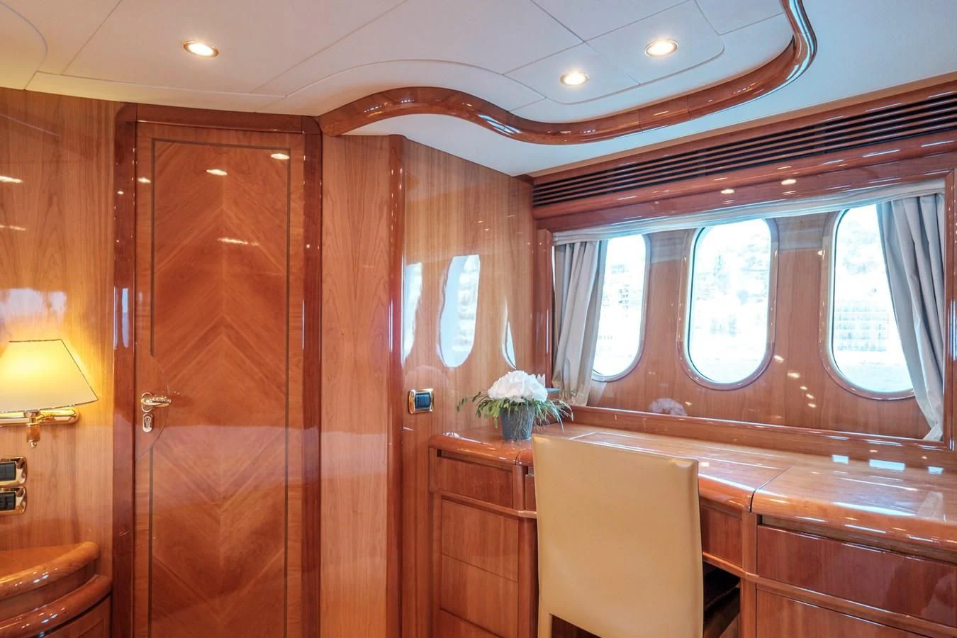 a room with wooden walls and a window with a wood door aboard BEIJA FLORE Yacht for Charter
