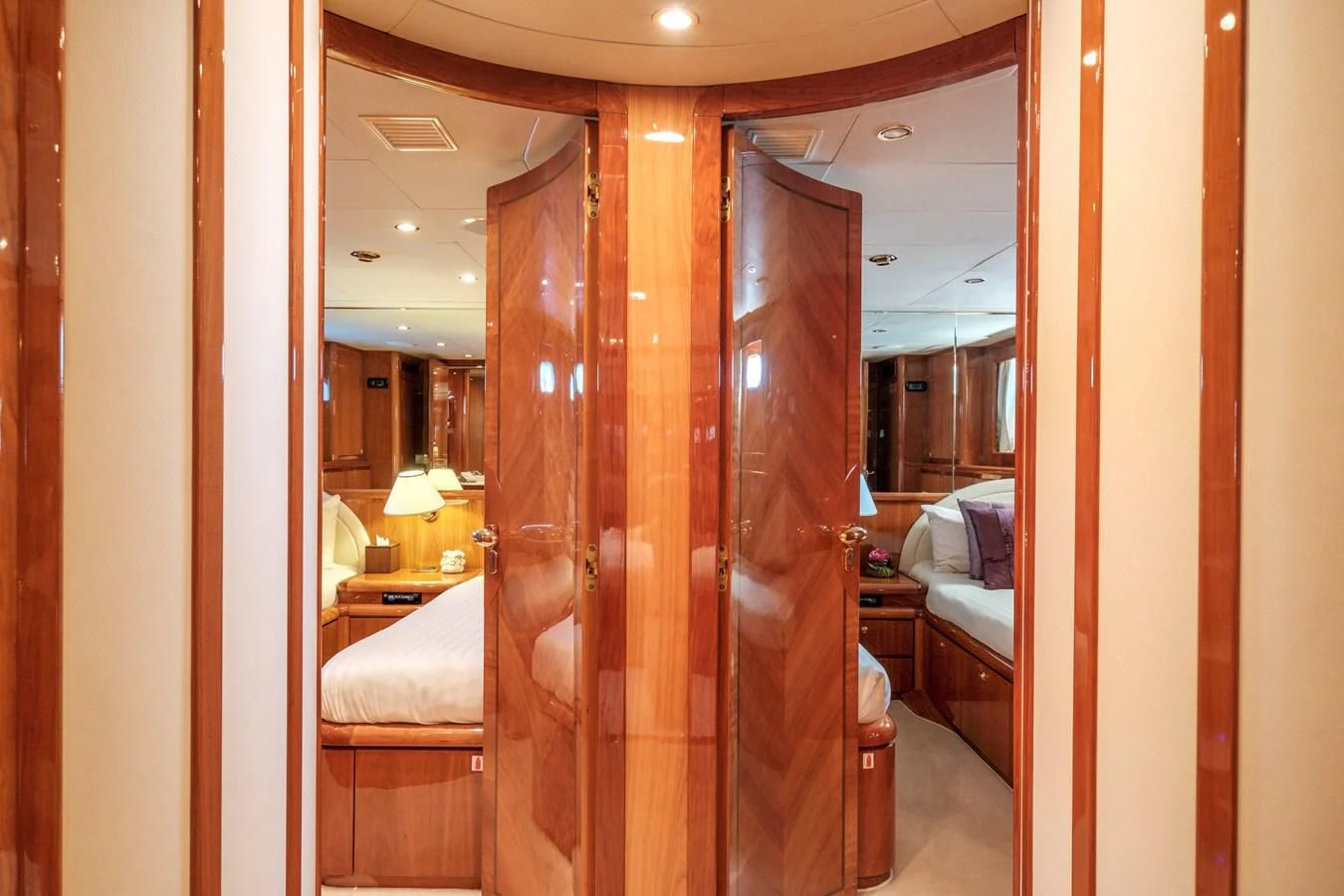 a room with a bed and a mirror aboard BEIJA FLORE Yacht for Charter