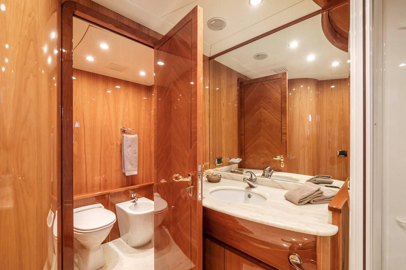 a bathroom with a sink toilet and a mirror aboard BEIJA FLORE Yacht for Charter