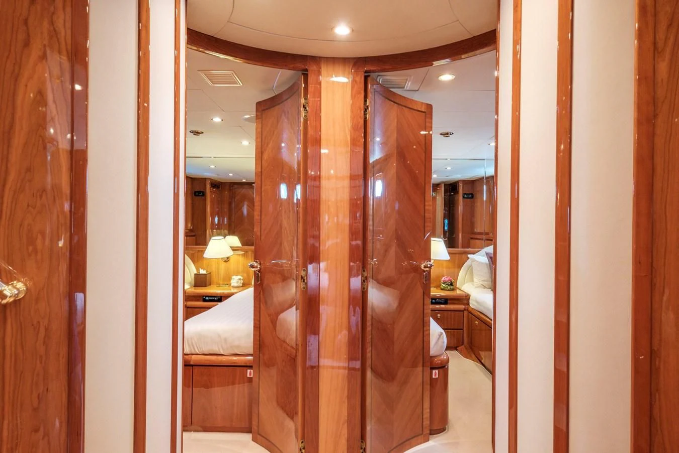 a bedroom with a large mirror aboard BEIJA FLORE Yacht for Charter