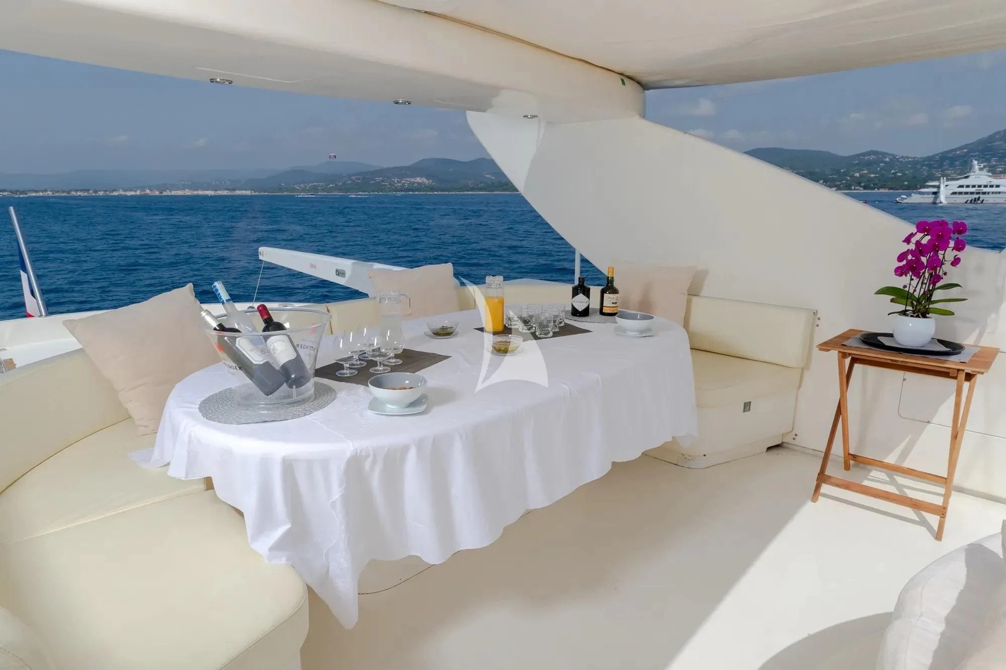 a table with a set of chairs and a view of the ocean aboard BEIJA FLORE Yacht for Charter