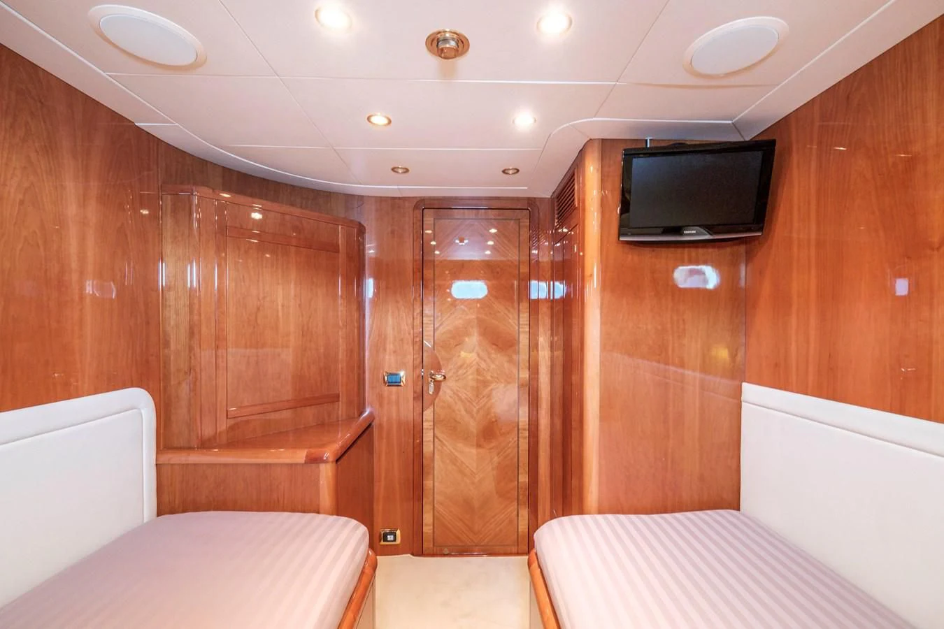 a room with a bed and a television aboard BEIJA FLORE Yacht for Charter