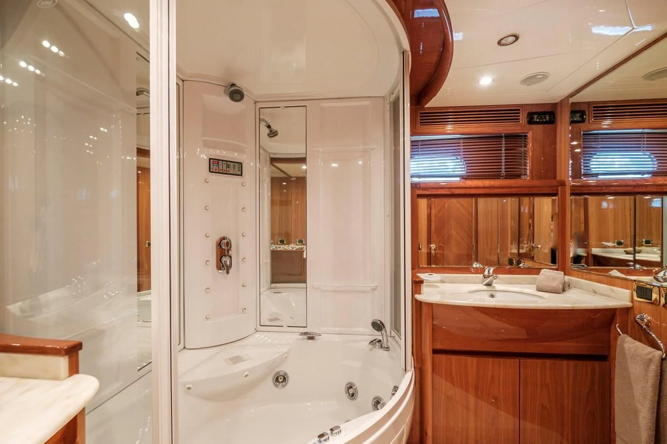 a bathroom with a tub sink and a mirror aboard BEIJA FLORE Yacht for Charter