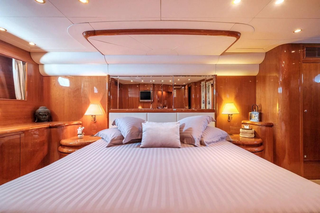 a bed with a white sheet and pillows aboard BEIJA FLORE Yacht for Charter