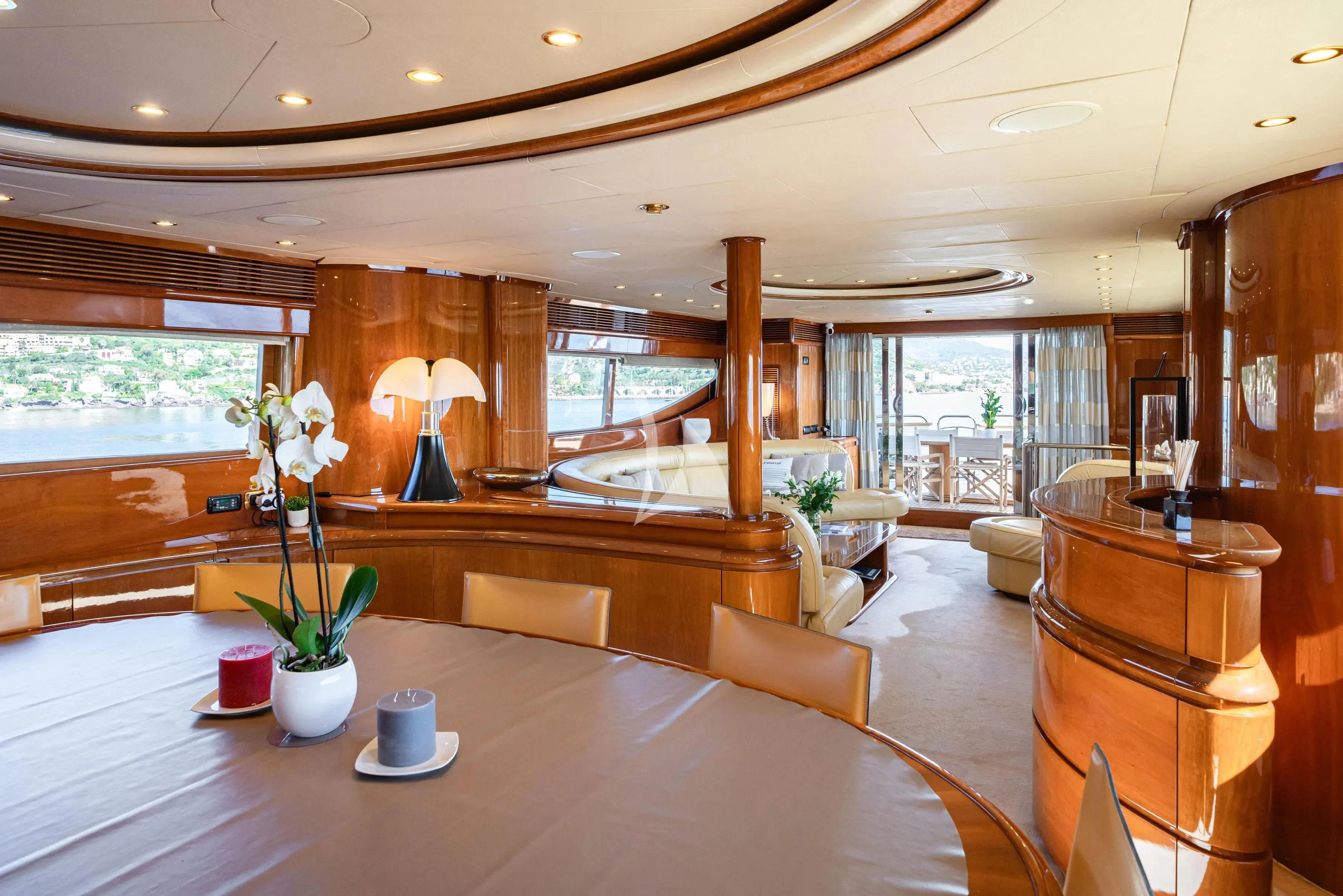a large room with a table and chairs aboard BEIJA FLORE Yacht for Charter