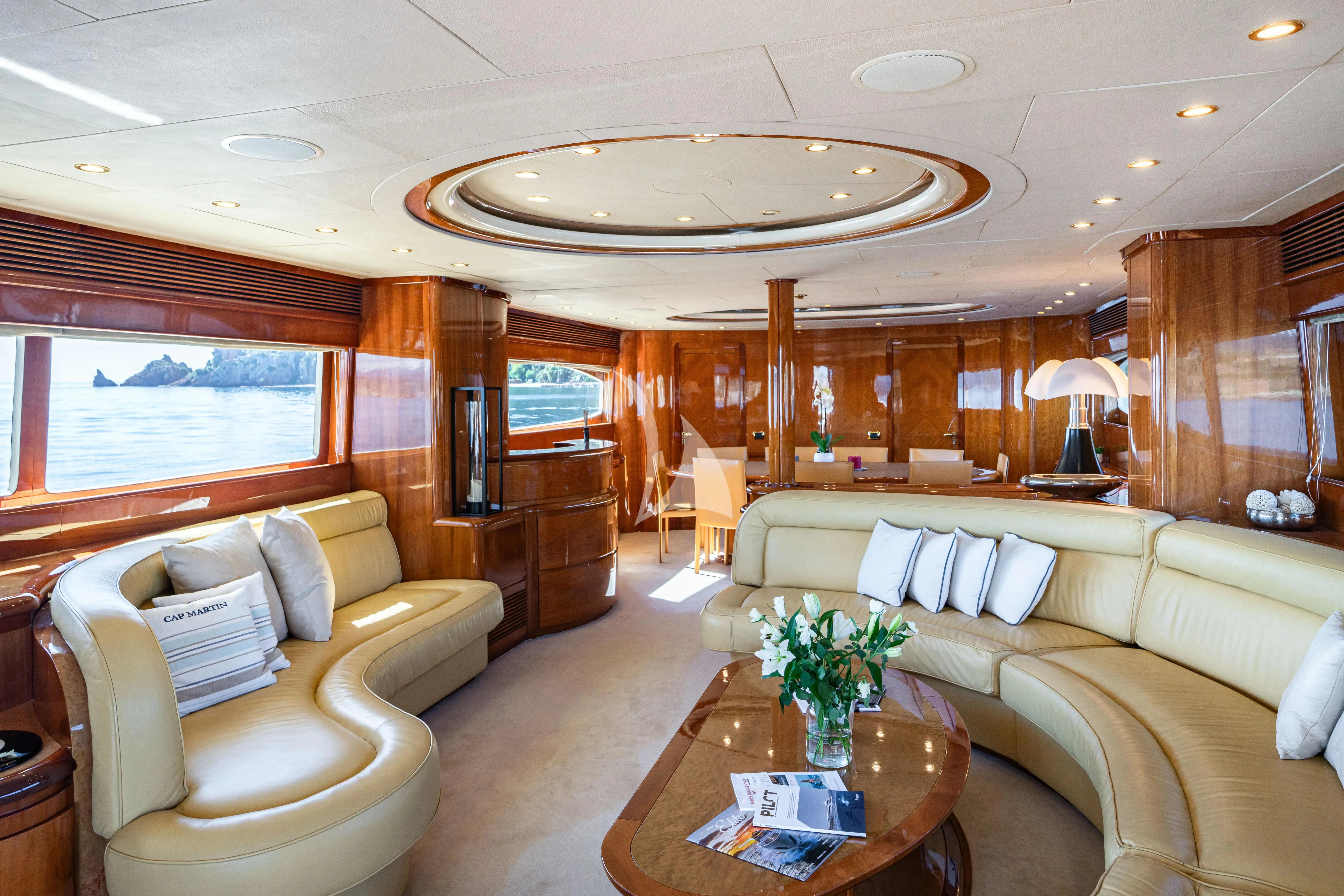 a living room with a large chandelier aboard BEIJA FLORE Yacht for Charter