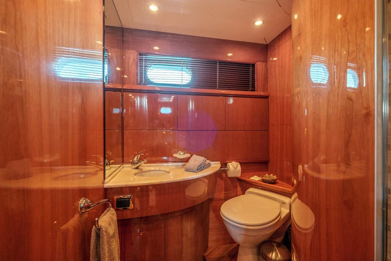 a bathroom with a toilet sink and a mirror aboard BEIJA FLORE Yacht for Charter