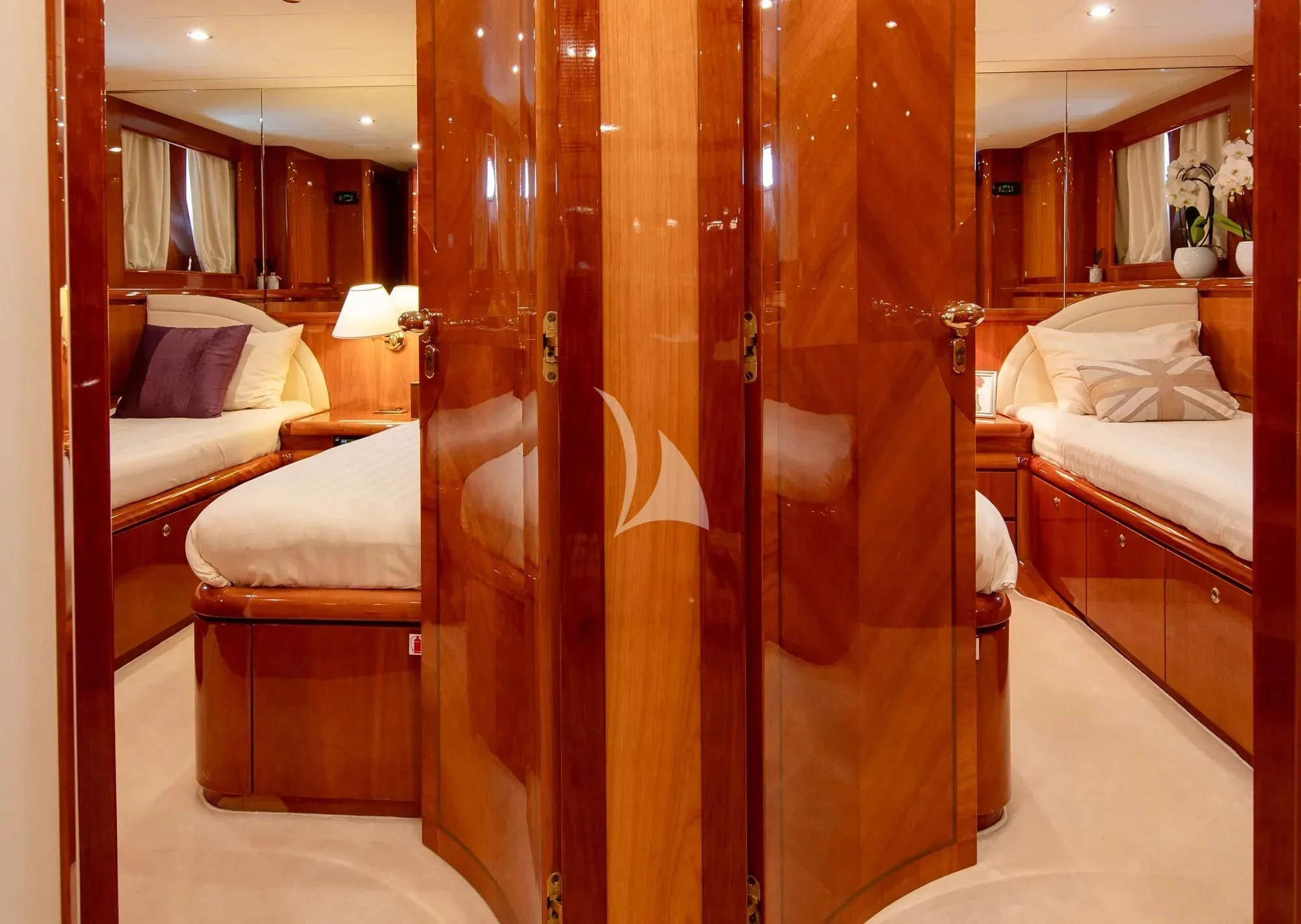 a room with a bed and a curtain aboard BEIJA FLORE Yacht for Charter