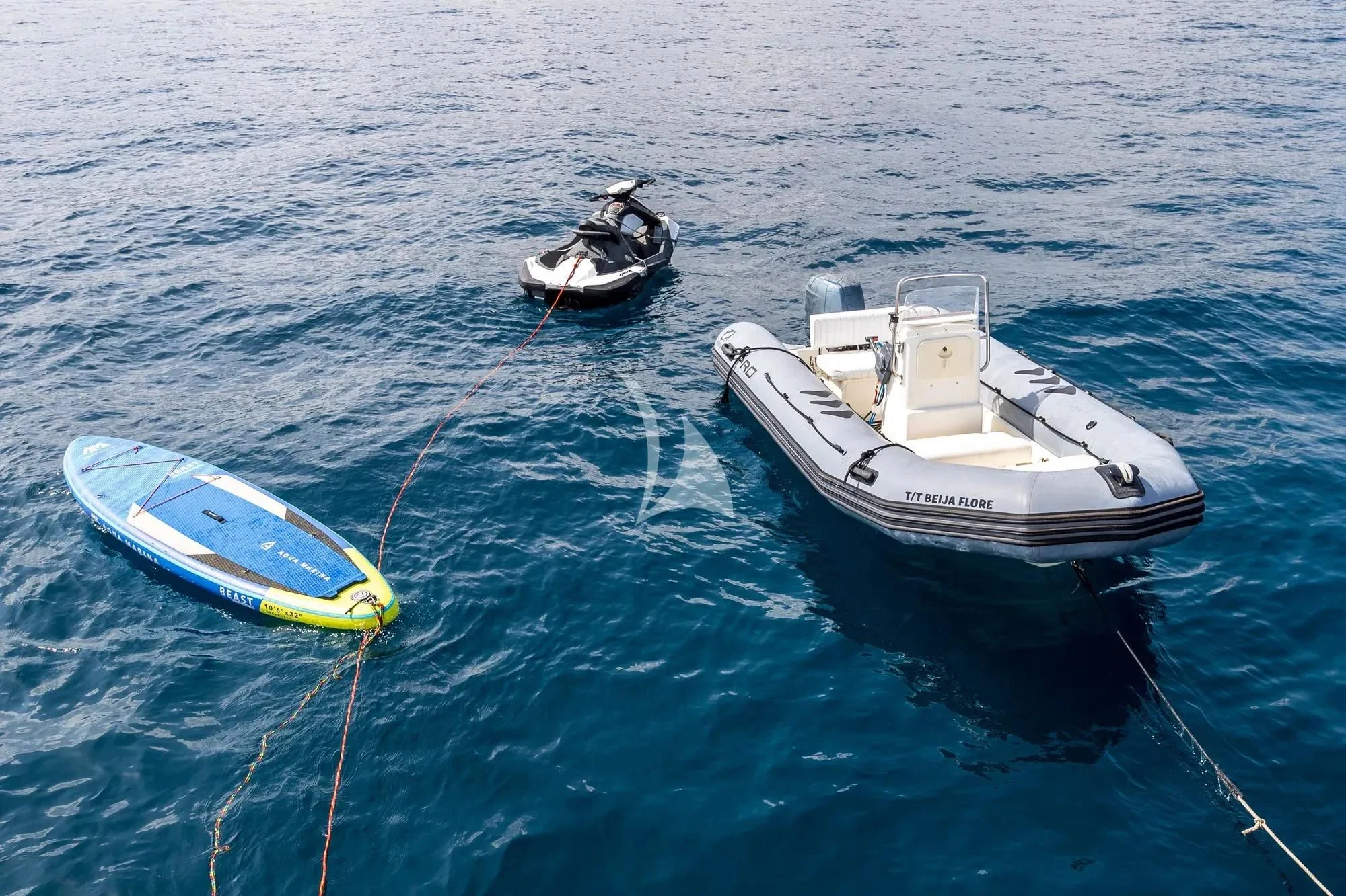 a boat and a surfboard in the water aboard BEIJA FLORE Yacht for Charter