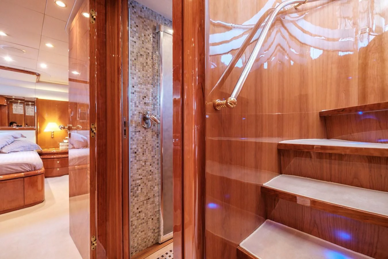a room with a bed and a wood door aboard BEIJA FLORE Yacht for Charter