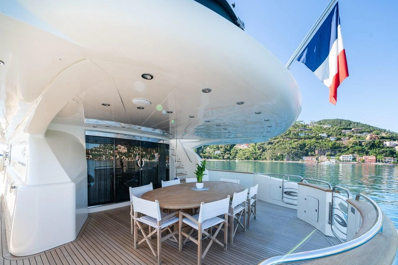 a table and chairs on a deck overlooking a body of water aboard BEIJA FLORE Yacht for Charter