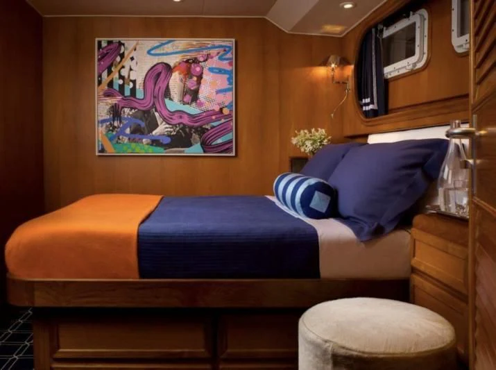 a bed with a blue pillow aboard GOING GALT Yacht for Sale