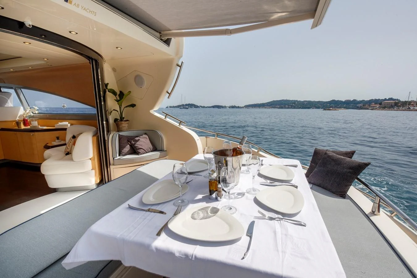 a table with plates and glasses on it aboard KOKAB Yacht for Charter