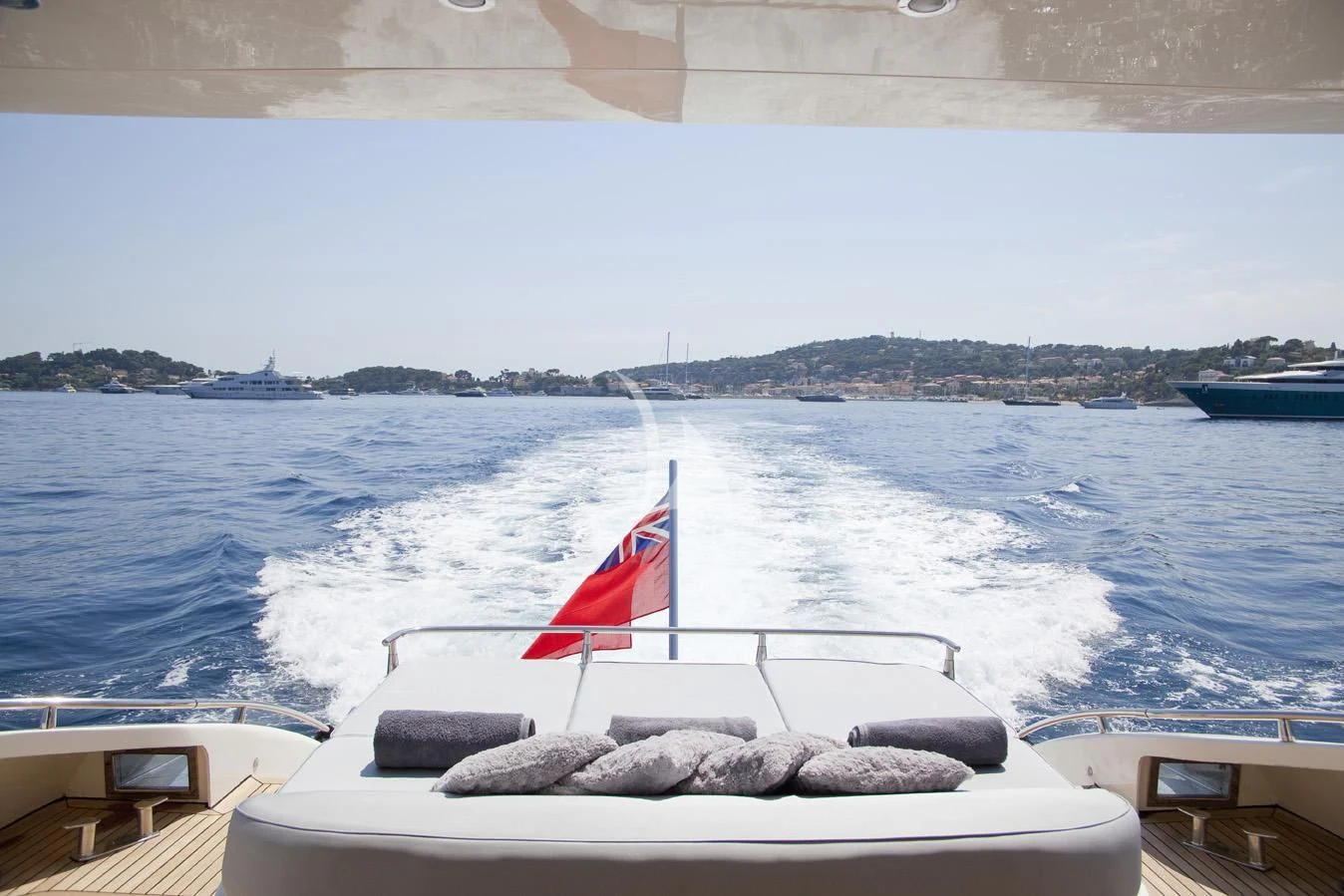 a boat with a flag on it aboard KOKAB Yacht for Charter