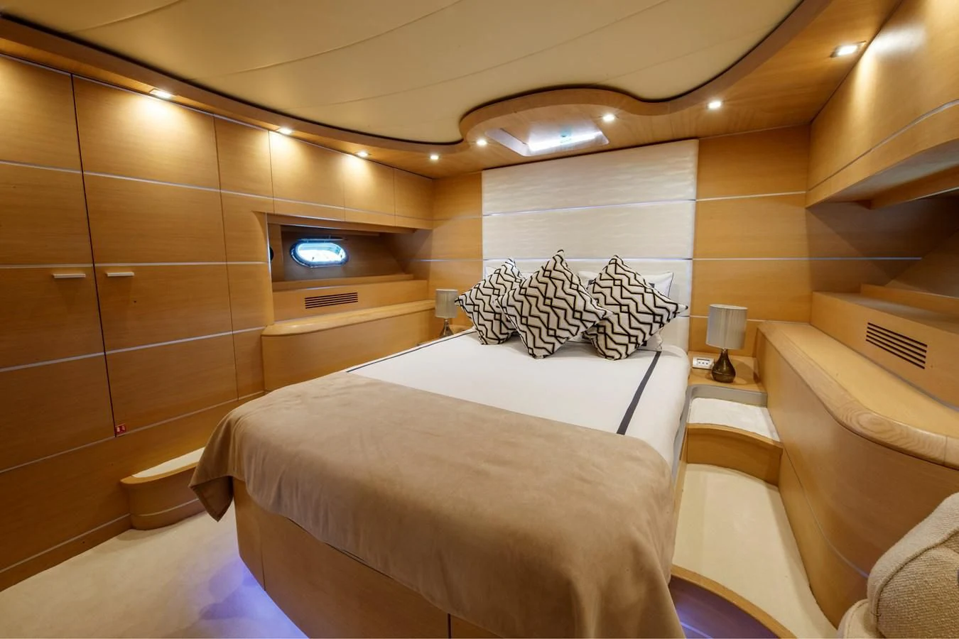 a room with a bed and a television aboard KOKAB Yacht for Charter