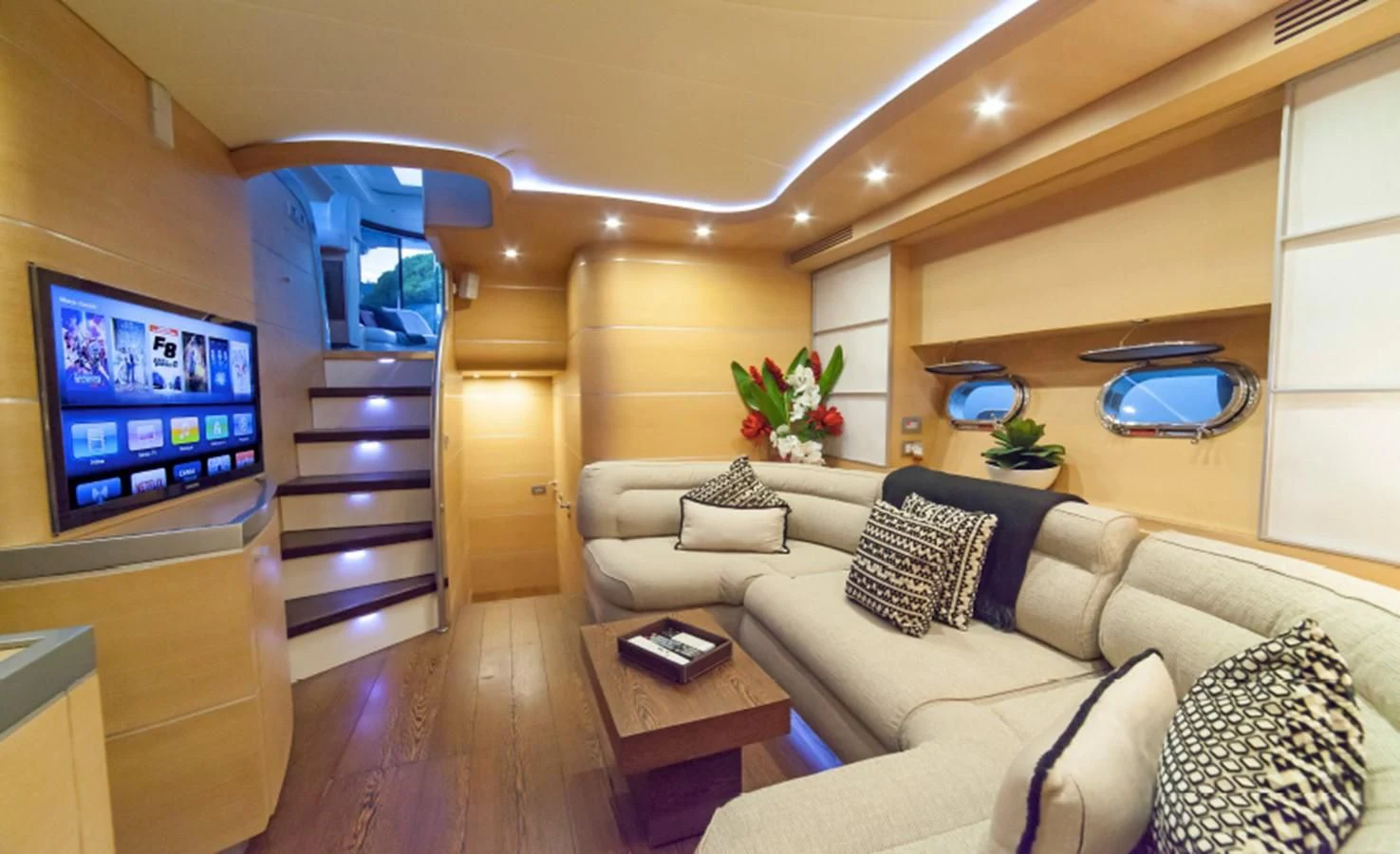 a living room with a large television aboard KOKAB Yacht for Charter