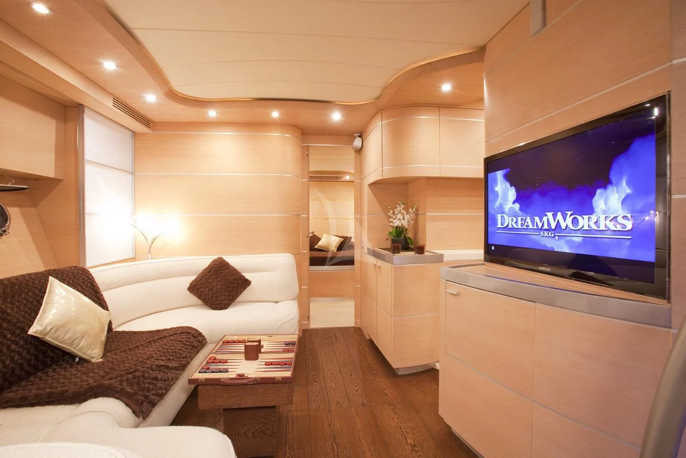 a living room with a tv aboard KOKAB Yacht for Charter
