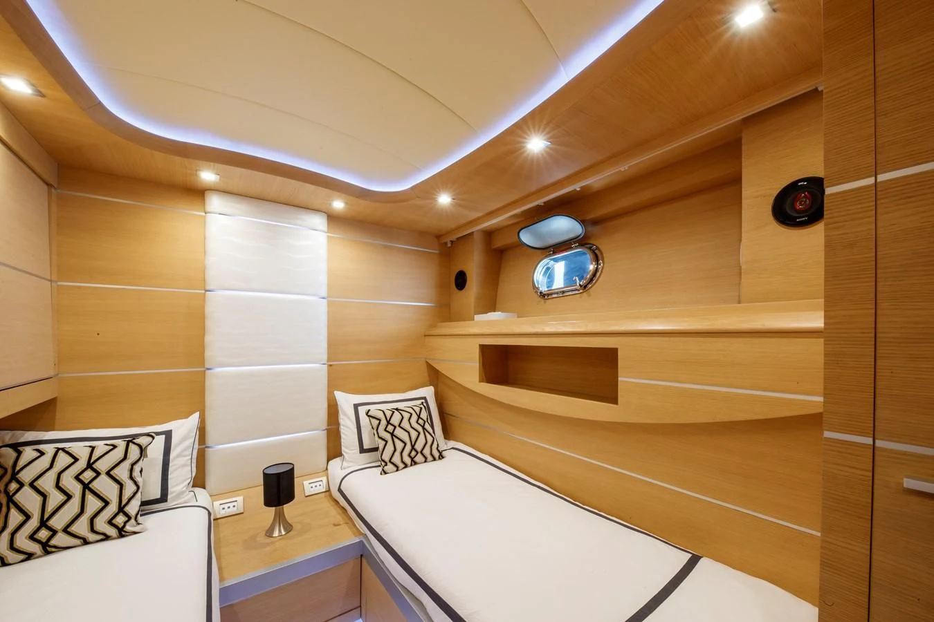 a room with a bed and a mirror aboard KOKAB Yacht for Charter