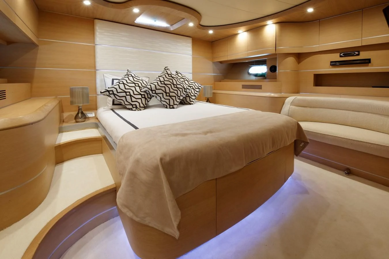 a room with a bed and a chair aboard KOKAB Yacht for Charter