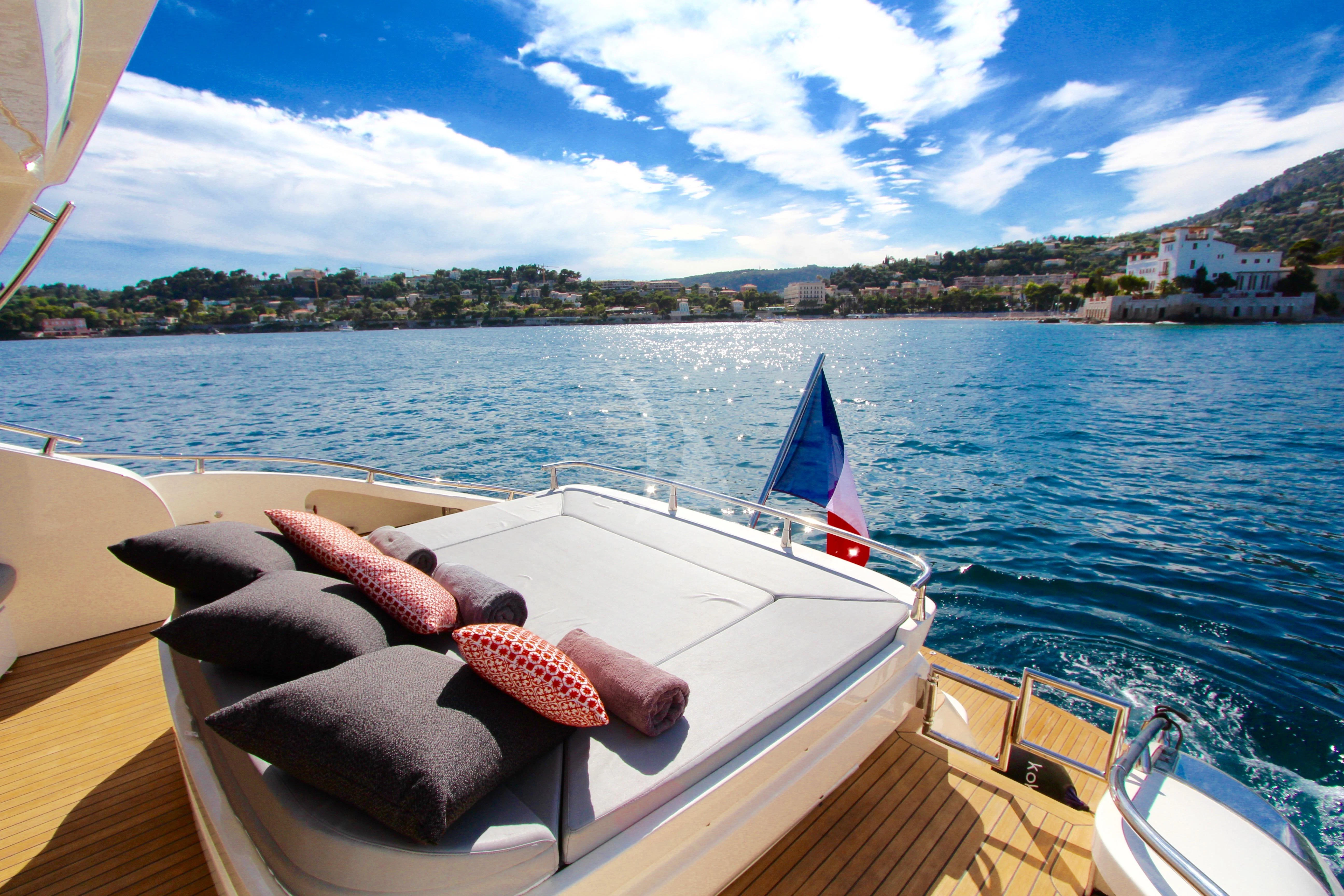 a boat with a flag on the front aboard KOKAB Yacht for Charter