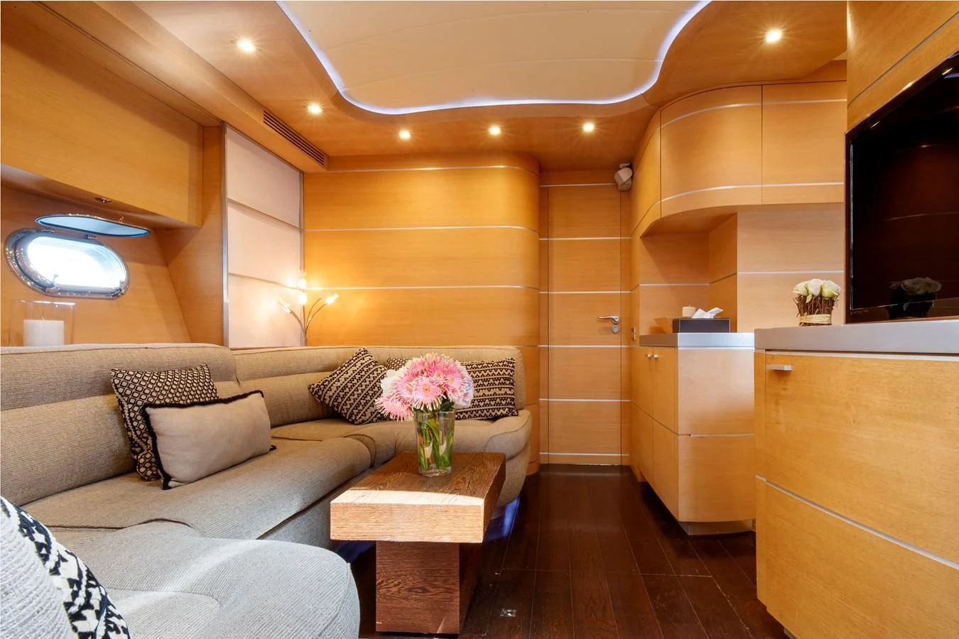 a living room with a couch and a table aboard KOKAB Yacht for Charter