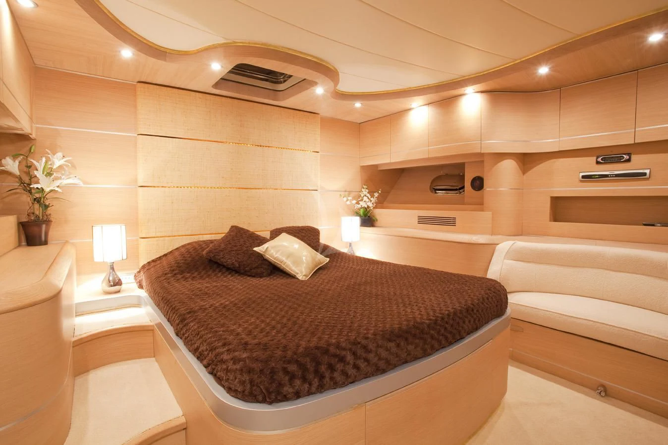 a modern looking bedroom with a large bed aboard KOKAB Yacht for Charter