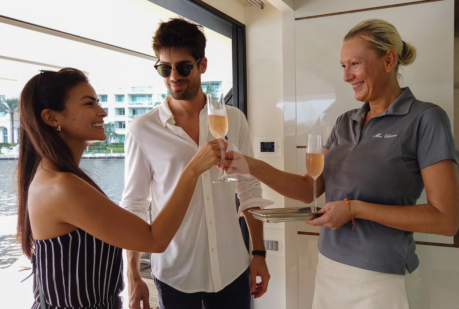 a man and a woman holding wine glasses aboard SWEET VIRGINIA Yacht for Sale