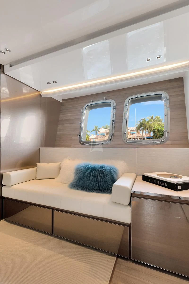 a white couch with a window aboard SWEET VIRGINIA Yacht for Sale