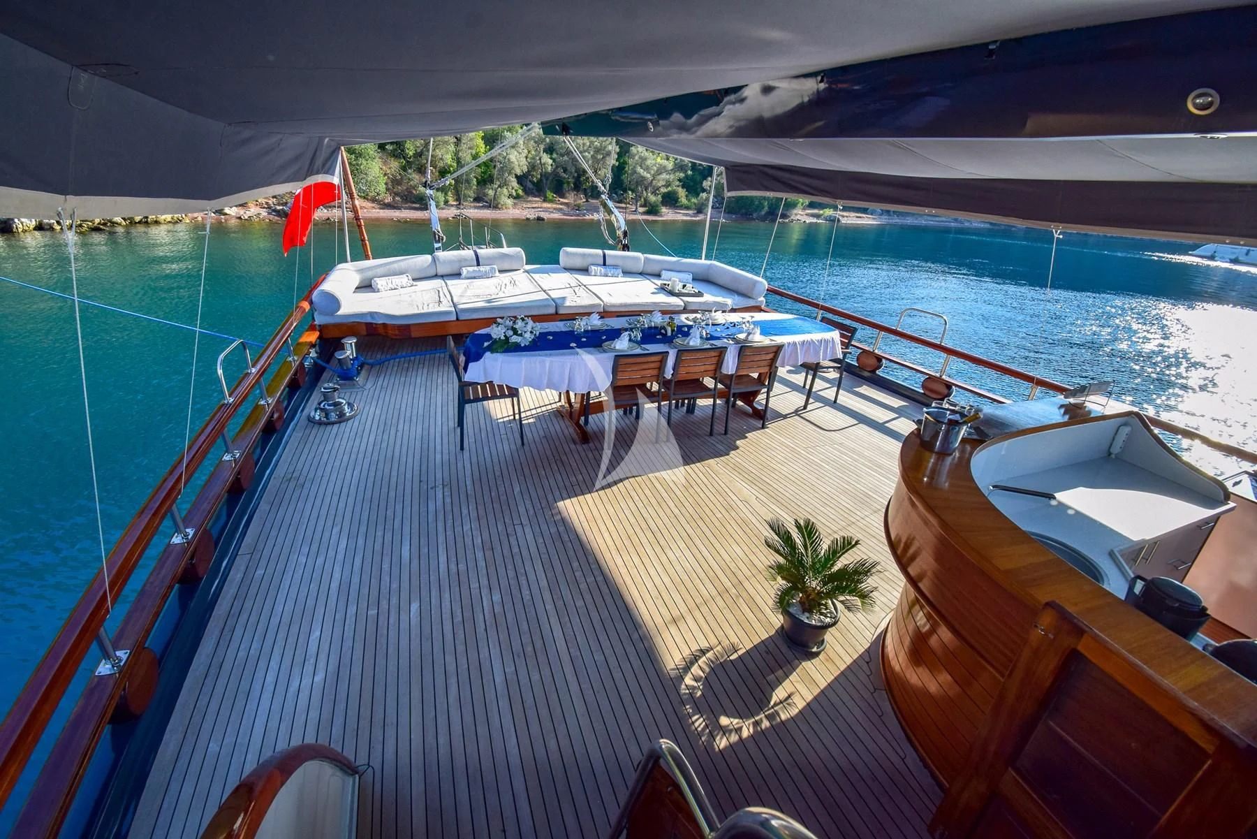 a deck with a pool and lounge chairs on it aboard UGUR Yacht for Sale