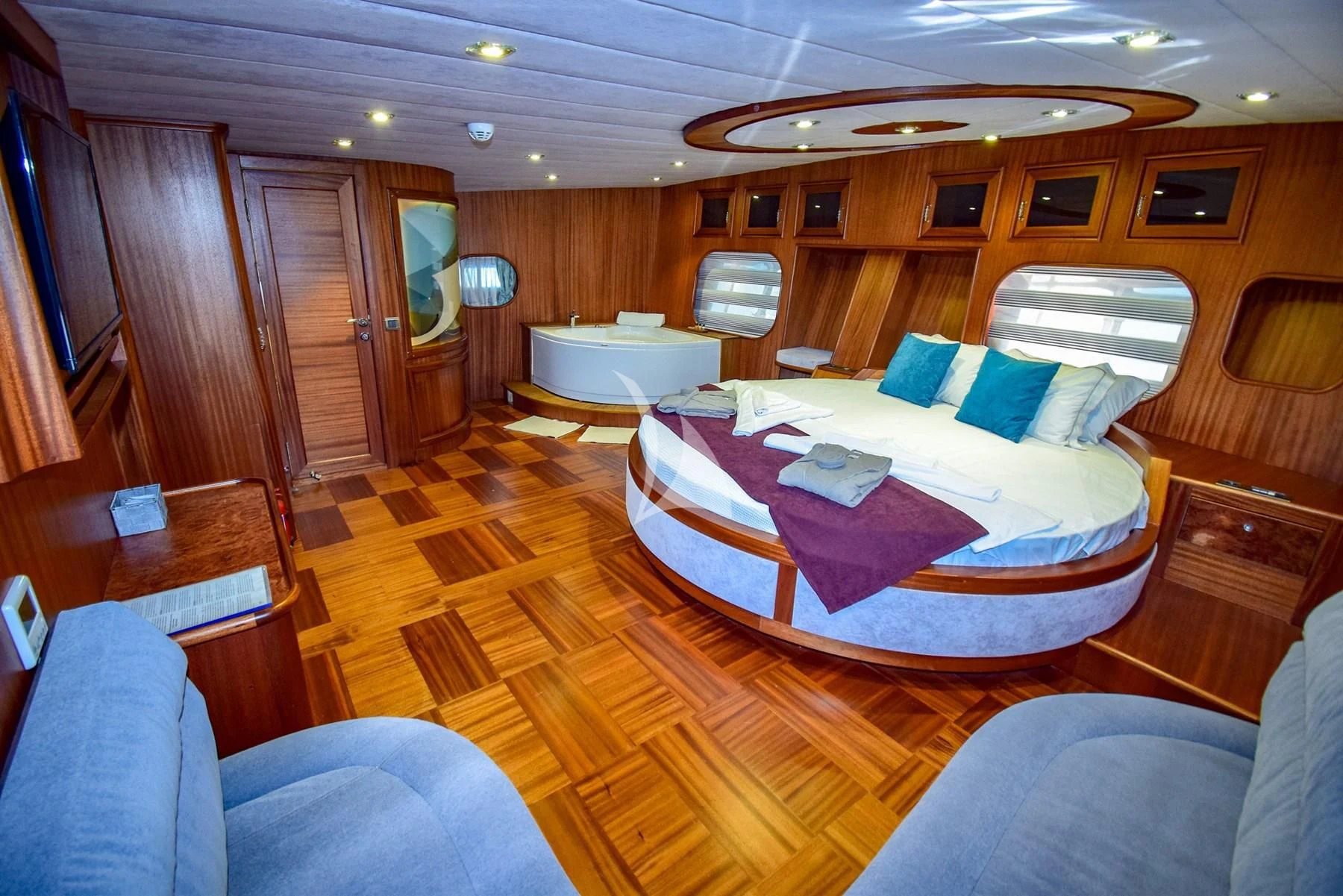 a room with a bed and a couch aboard UGUR Yacht for Sale