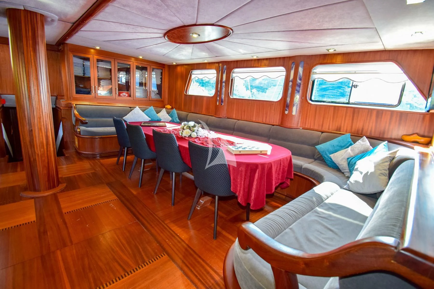 a room with a table chairs and a couch aboard UGUR Yacht for Sale