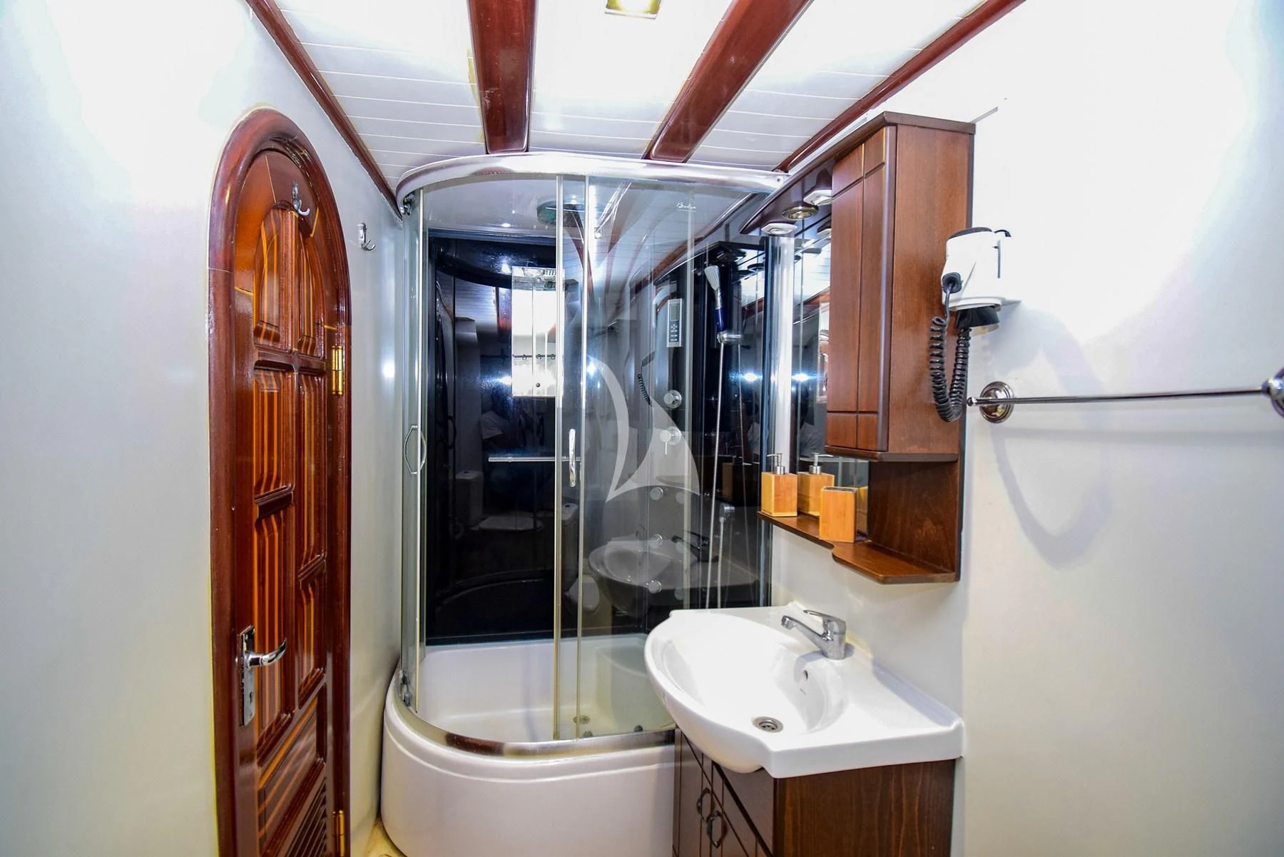 a bathroom with a glass shower aboard UGUR Yacht for Sale