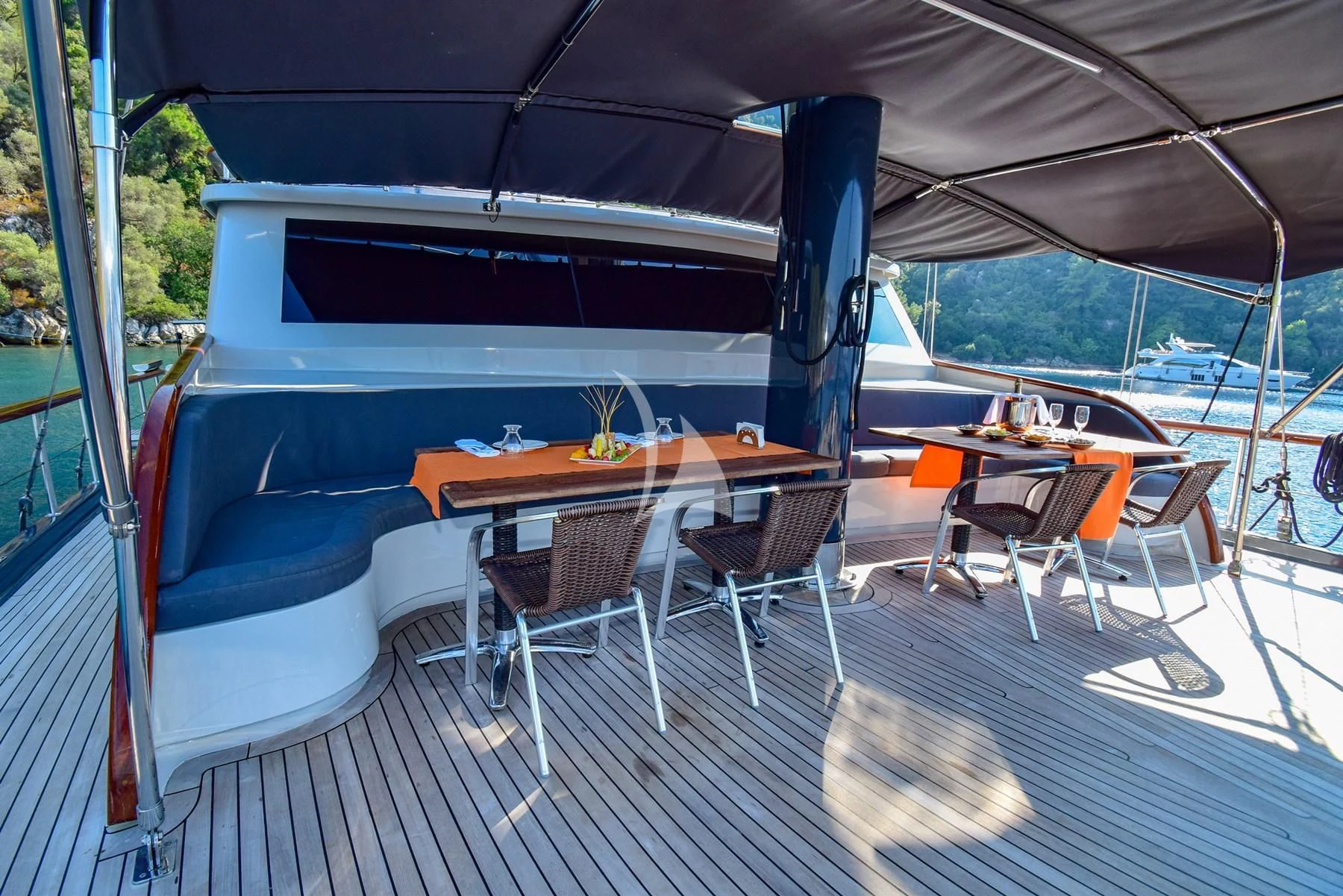 a boat with a table and chairs on a deck aboard UGUR Yacht for Sale