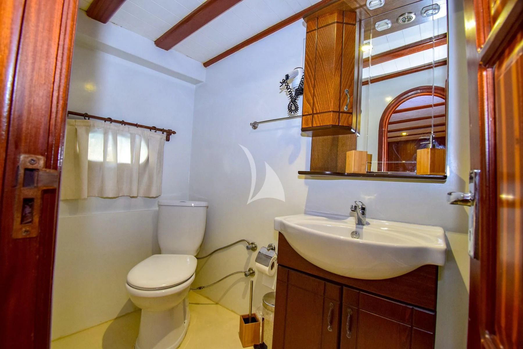 a bathroom with a toilet sink and a mirror aboard UGUR Yacht for Sale