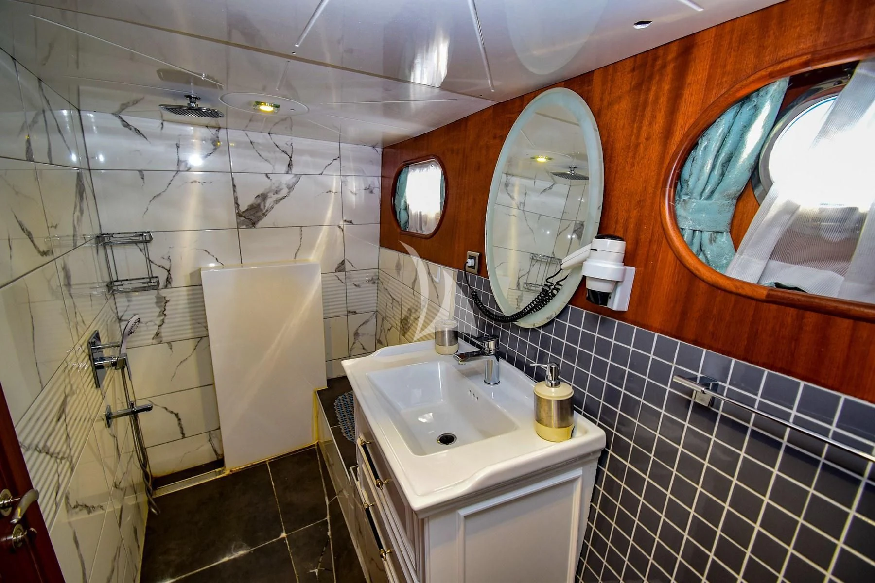 a bathroom with a sink and a mirror aboard UGUR Yacht for Sale