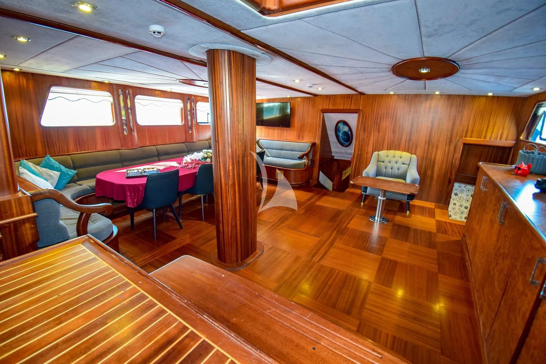 a room with a wood floor and a table and chairs aboard UGUR Yacht for Sale