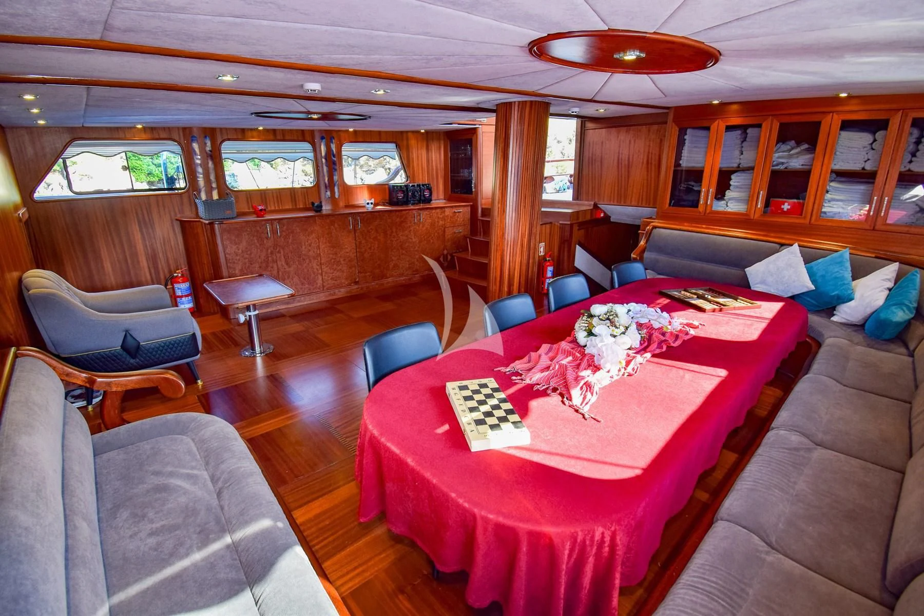 a room with a table and chairs aboard UGUR Yacht for Sale