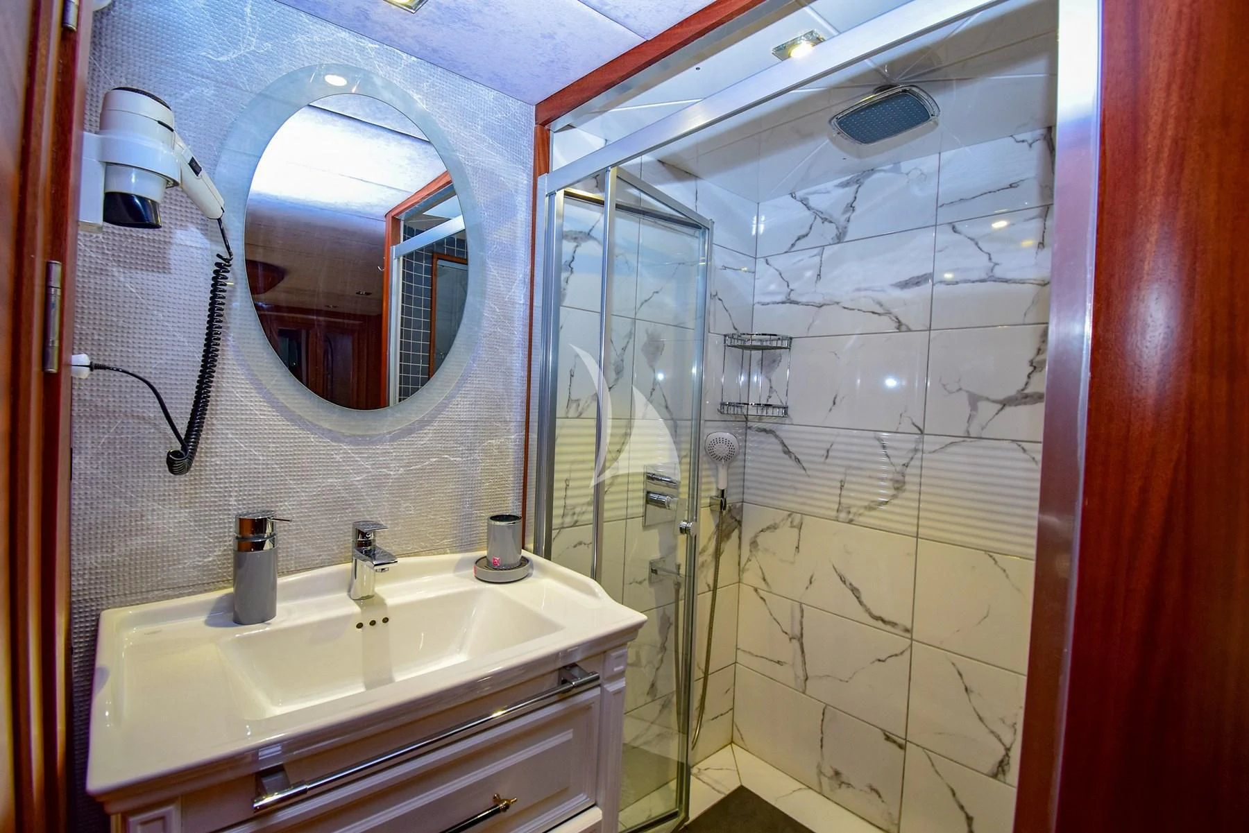 a bathroom with a large mirror aboard UGUR Yacht for Sale