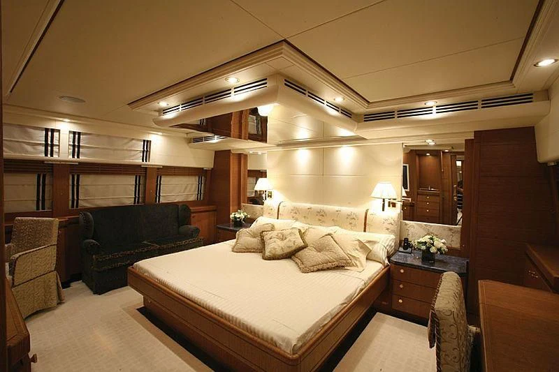 a large bedroom with a bed and a couch aboard ALFA XII Yacht for Sale