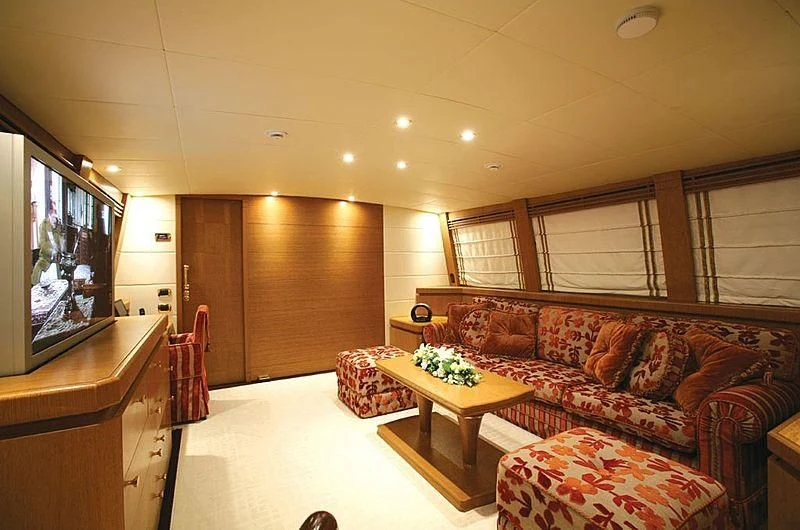 a living room with a couch and a tv aboard ALFA XII Yacht for Sale