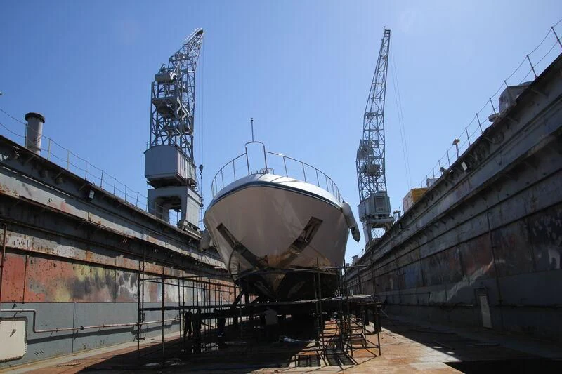 a large white boat in a dock aboard ALFA XII Yacht for Sale