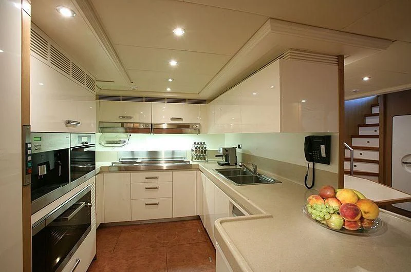 a kitchen with a bowl of fruit aboard ALFA XII Yacht for Sale