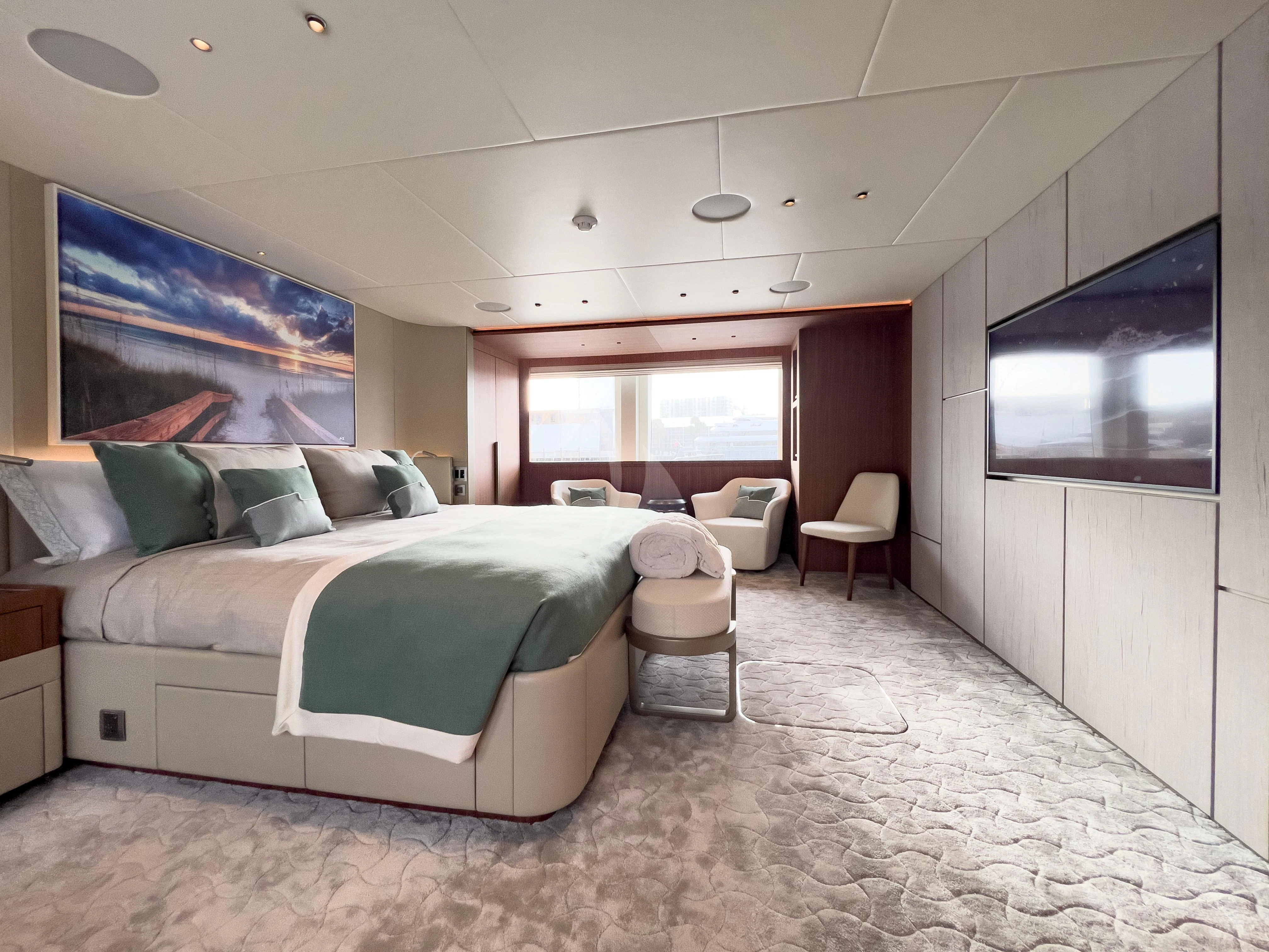 a bedroom with a bed and a tv aboard RISING DAWN Yacht for Sale