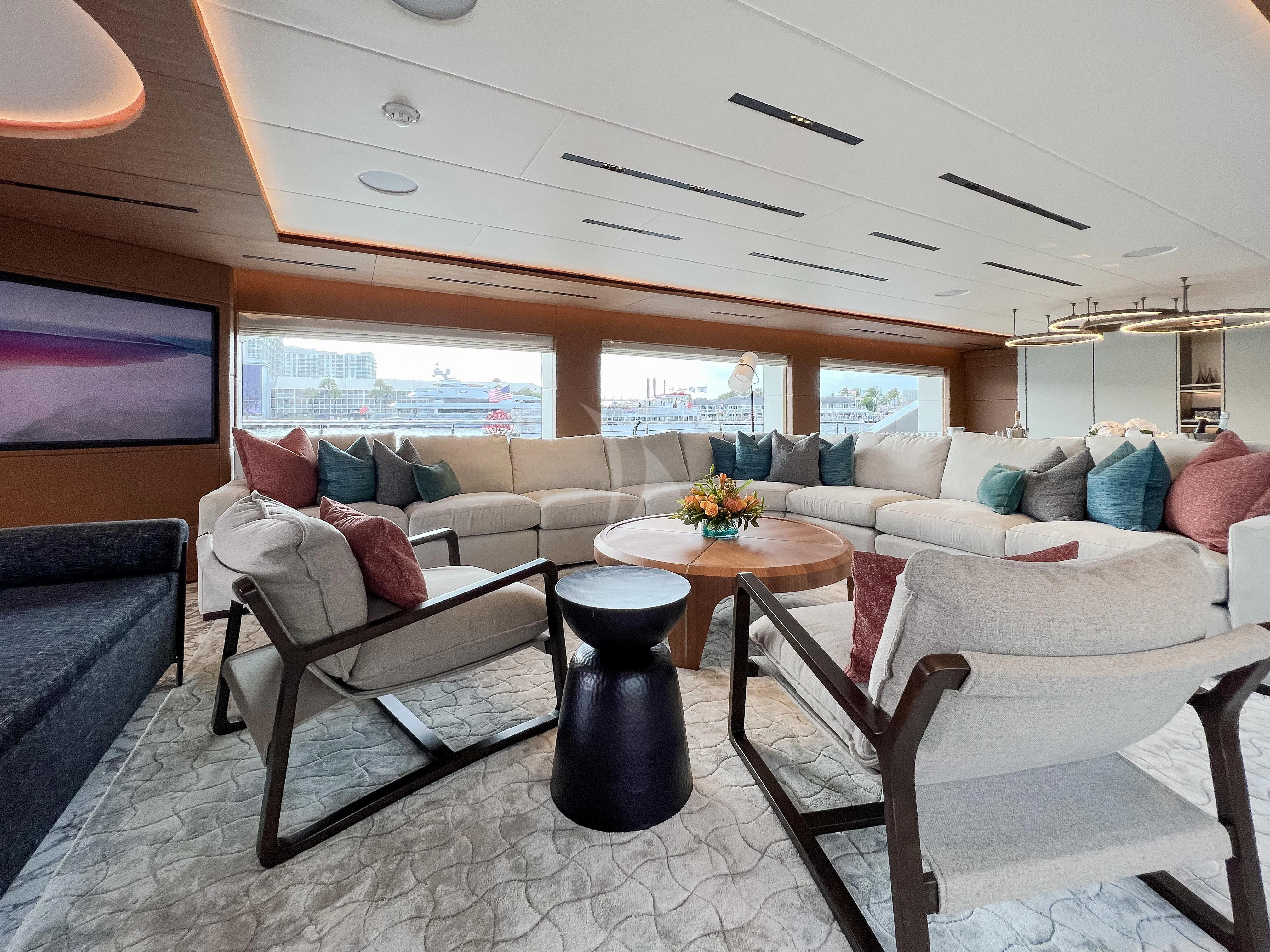 a living room with a couch and a table aboard RISING DAWN Yacht for Sale