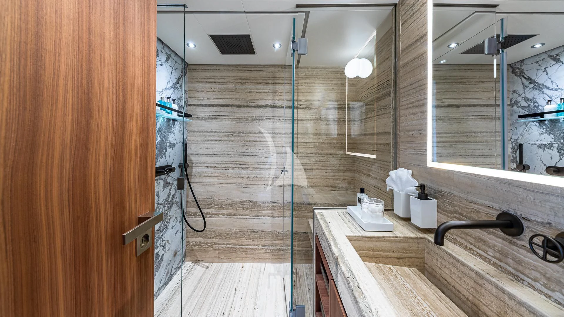 a bathroom with a shower unit and sink aboard RISING DAWN Yacht for Sale