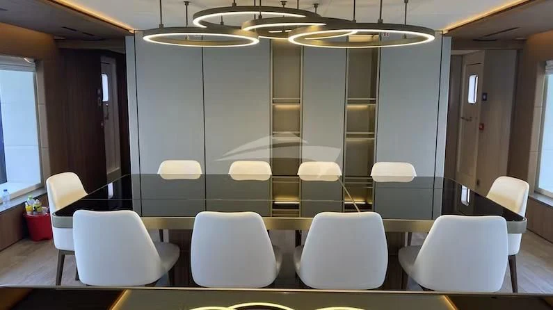a room with chairs and a table aboard RISING DAWN Yacht for Sale